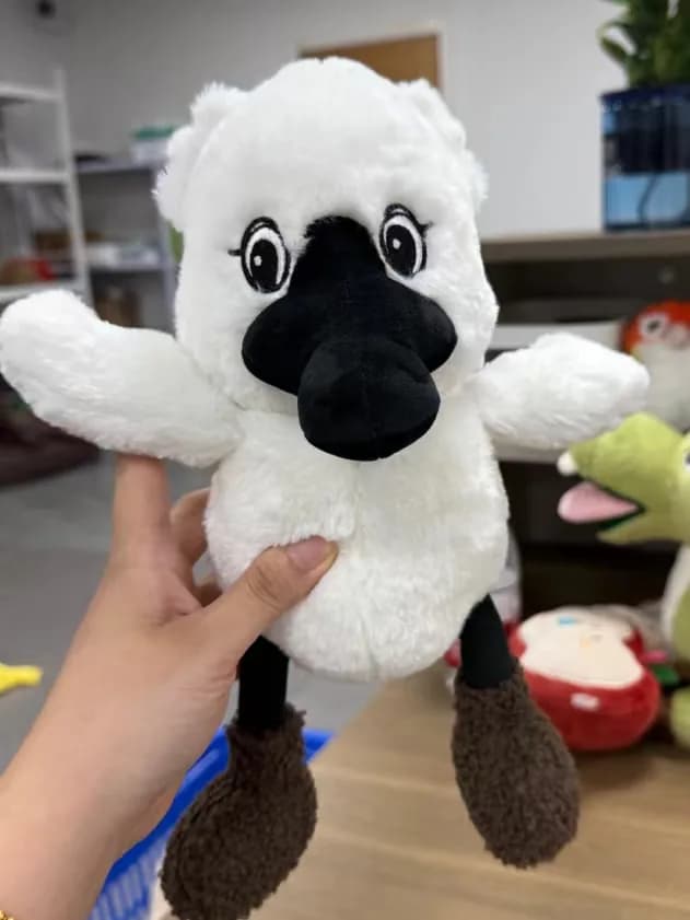 White alpaca stuffed animal with curly fur
