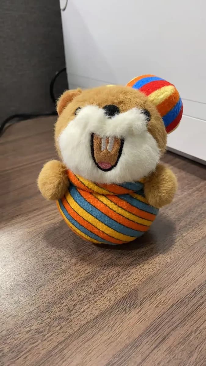 Dog plush toy with a striped fabric ball