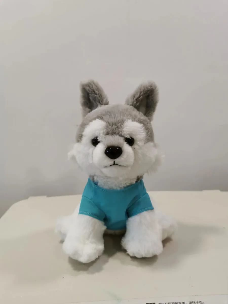 Husky puppy plush toy wearing a knitted top