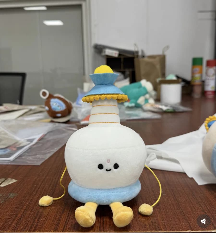 White character plush toy with stubby legs