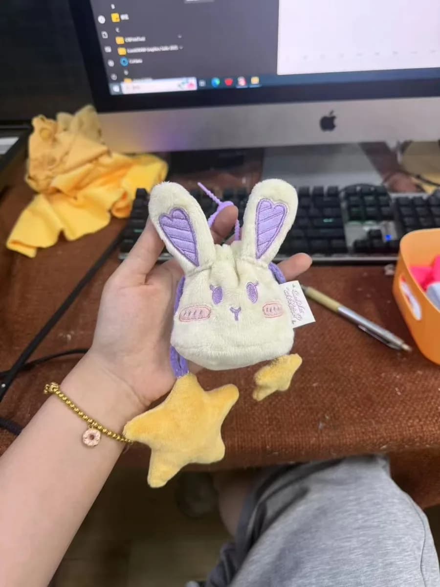 Custom rabbit plush keychain with printed ears held in hand