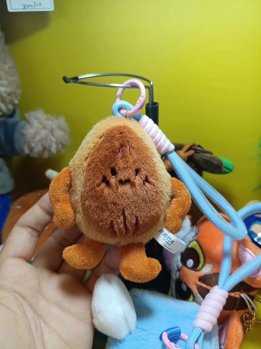 Set of custom plush charms clipped to a carabiner