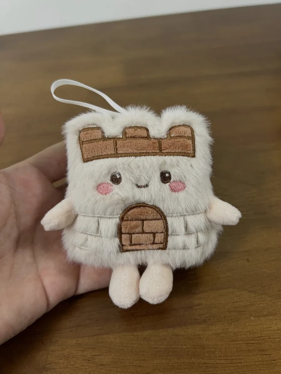 Fortress-shaped plush keychain with appliqué brick wall