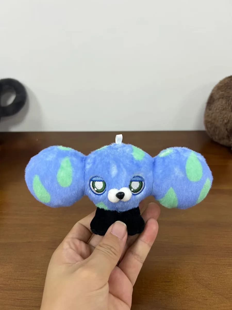 Koala plush charm on a globe-shaped body