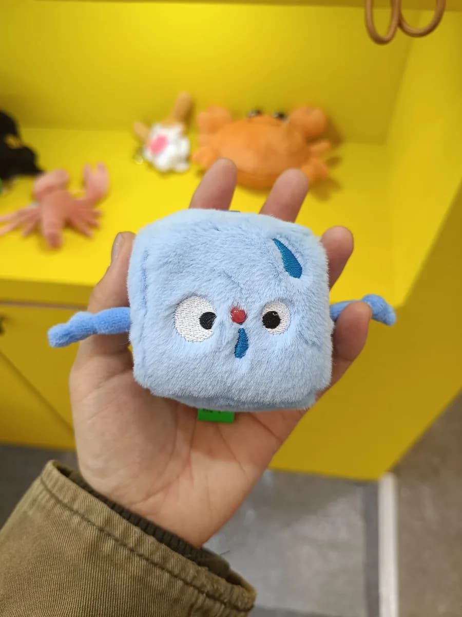 Square plush charm with embroidered logo