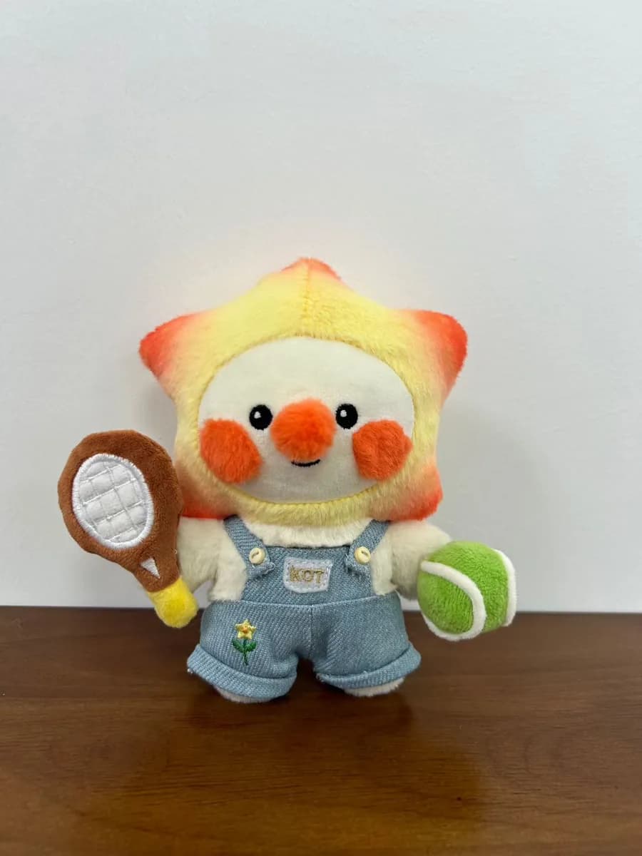 Bird mascot plush holding a tennis racket