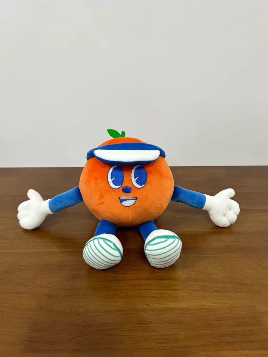 Orange character mascot plush with moulded arms
