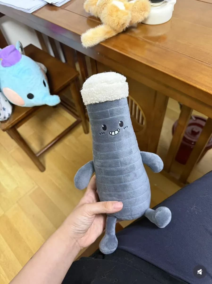 Bottle-shaped plush toy with printed label