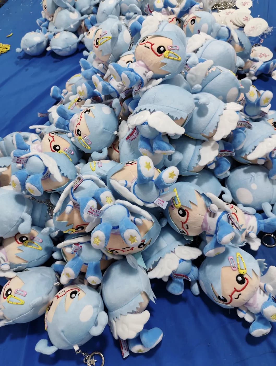 Bulk run of blue plush characters on the packing table