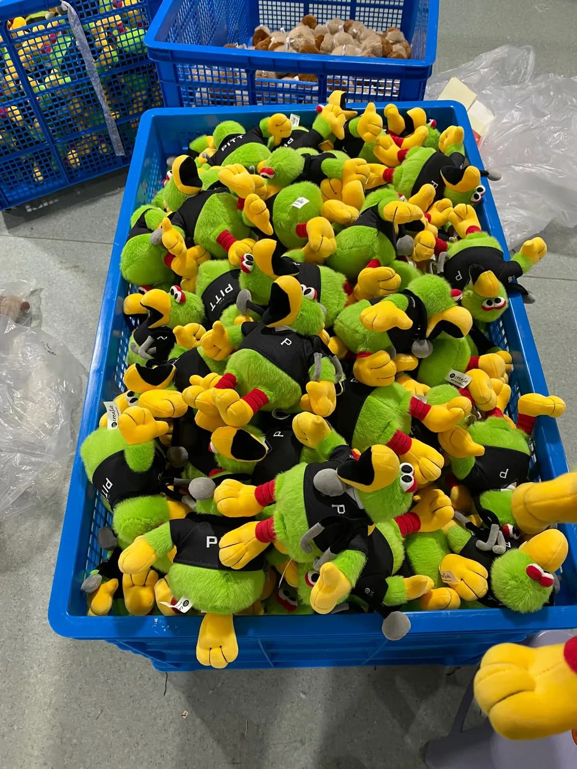 Crate of finished claw machine plush toys ready for packing