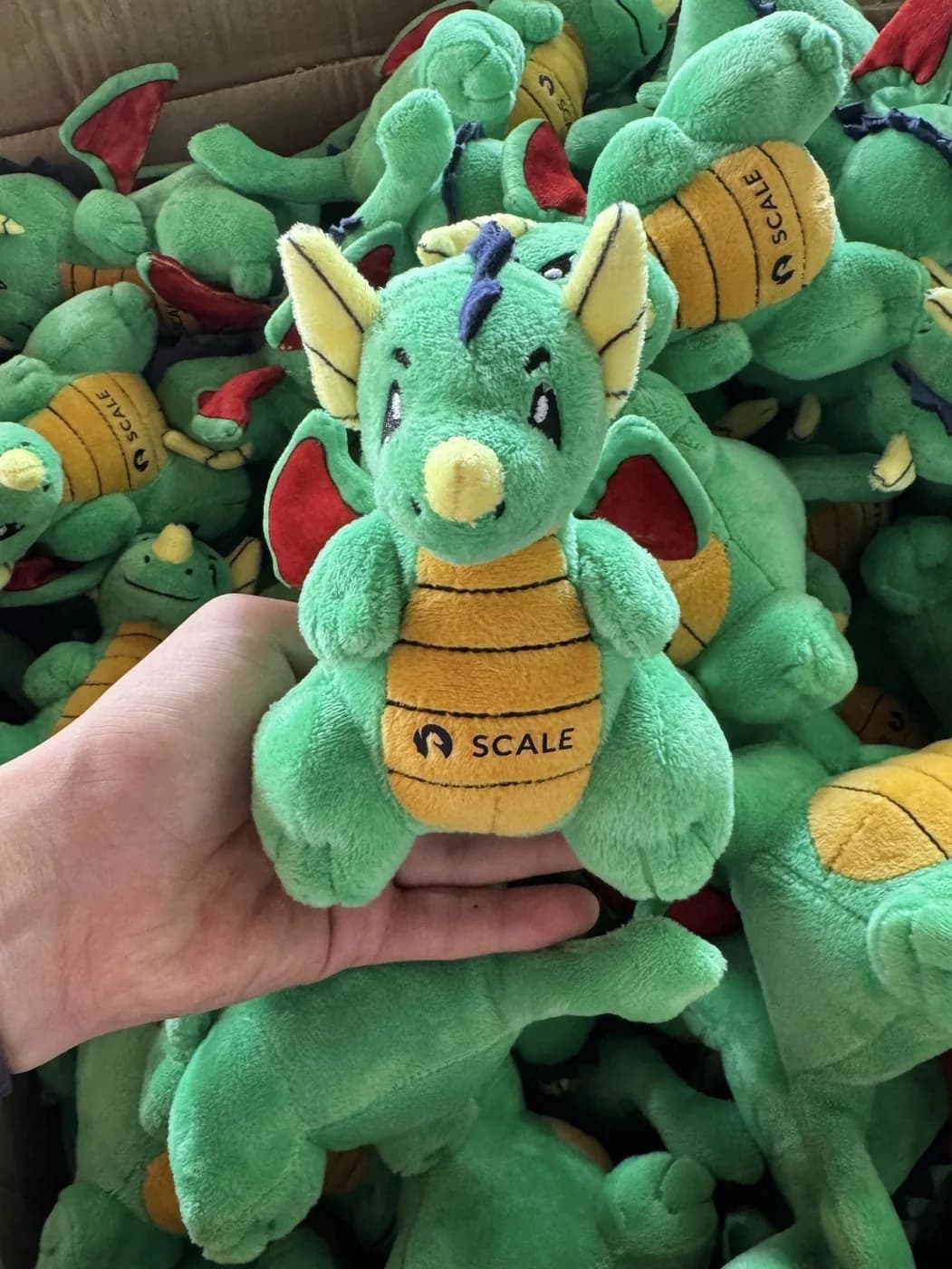 Handful of finished promotional plush toys straight off the line