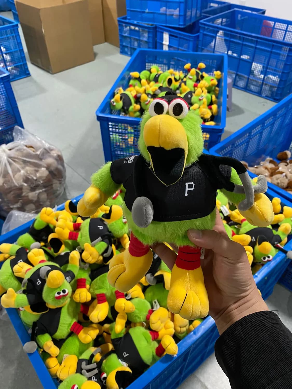 Operator checking finished plush toys during final QC