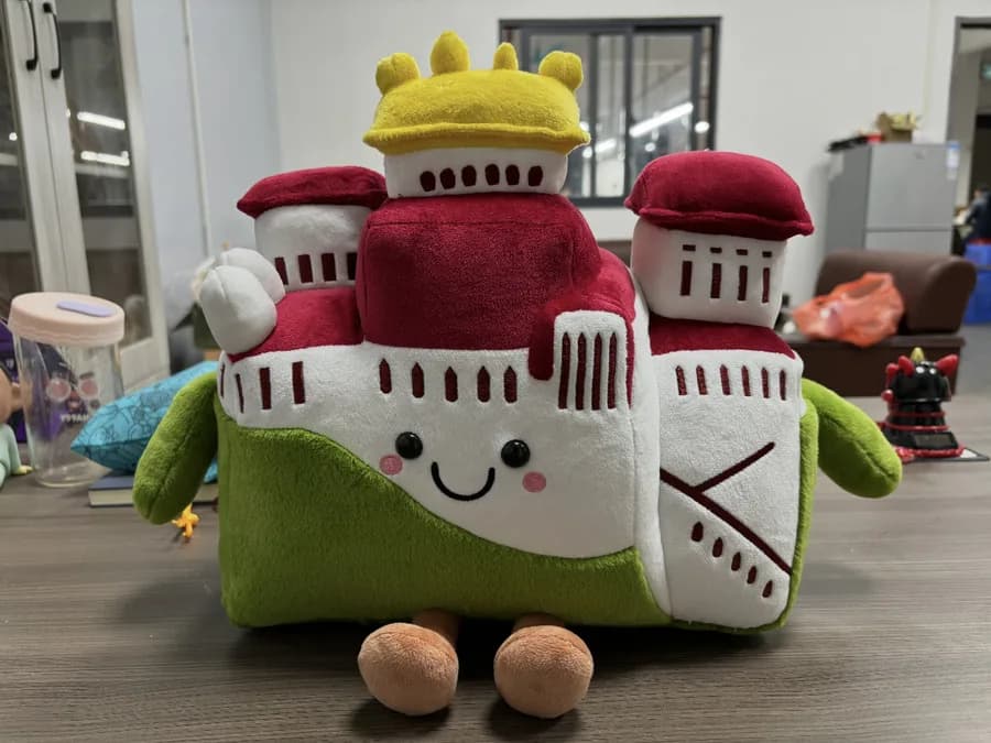 Castle and ship plush souvenirs for a heritage site