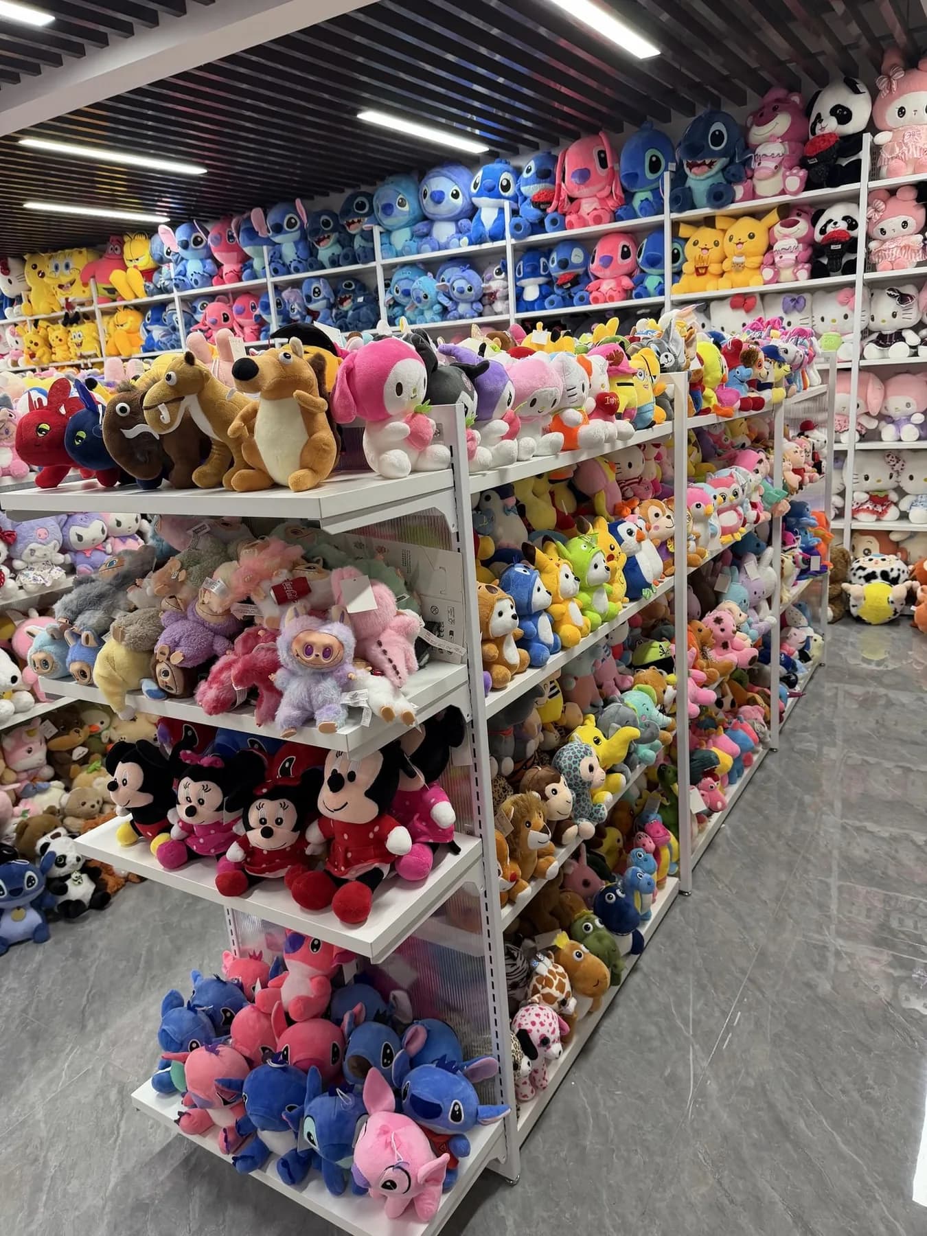 Plush toys sorted by style on warehouse shelves